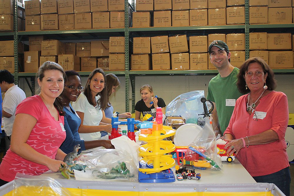 Volunteers at Cradles and Crayons sorting toys and clothes